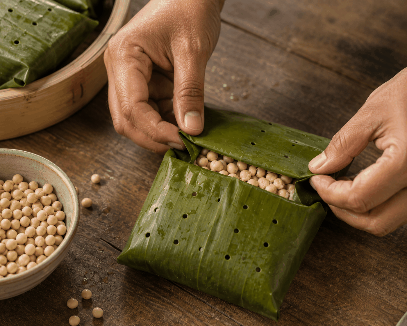 Hands beginning a batch of tempeh fermentation